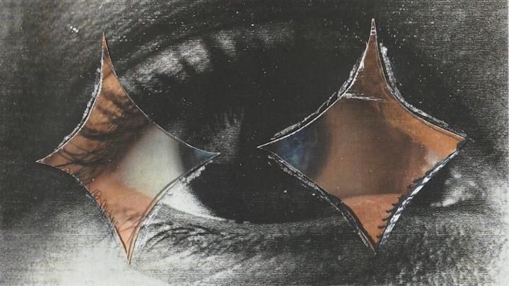 Two pointed, metallic shapes cut from a dark mixed-media surface